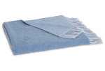 The Paley Cashmere Throw by Matouk, in light blue Mongolian cashmere with a fringed edge, is shown folded on a white background.