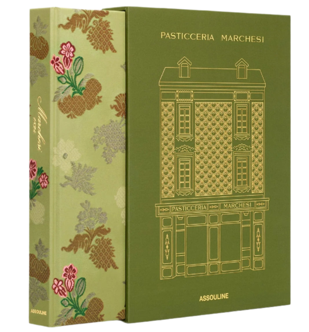 A gold-embossed book cover illustrates a building labeled "Pasticceria Marchesi," renowned since 1824. The spine's floral designs evoke holiday panettone aromas, with the publisher's name, Assouline, elegantly placed at the bottom.