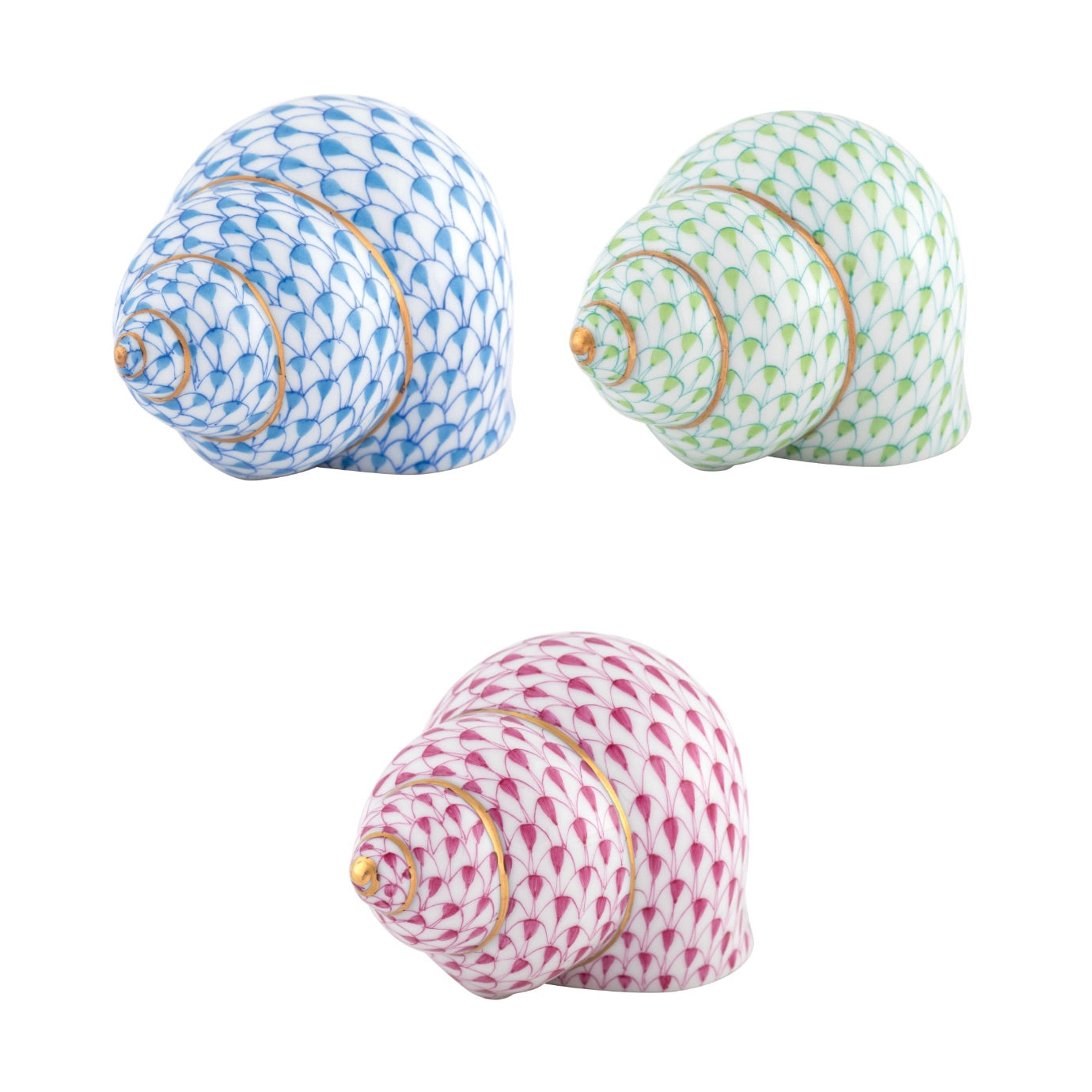 The Herend Periwinkle Shells feature three hand-painted ceramic shells in blue, green, and pink with gold accents and scale-like patterns, displayed on a white background—an artistic showcase from the renowned Herend brand.