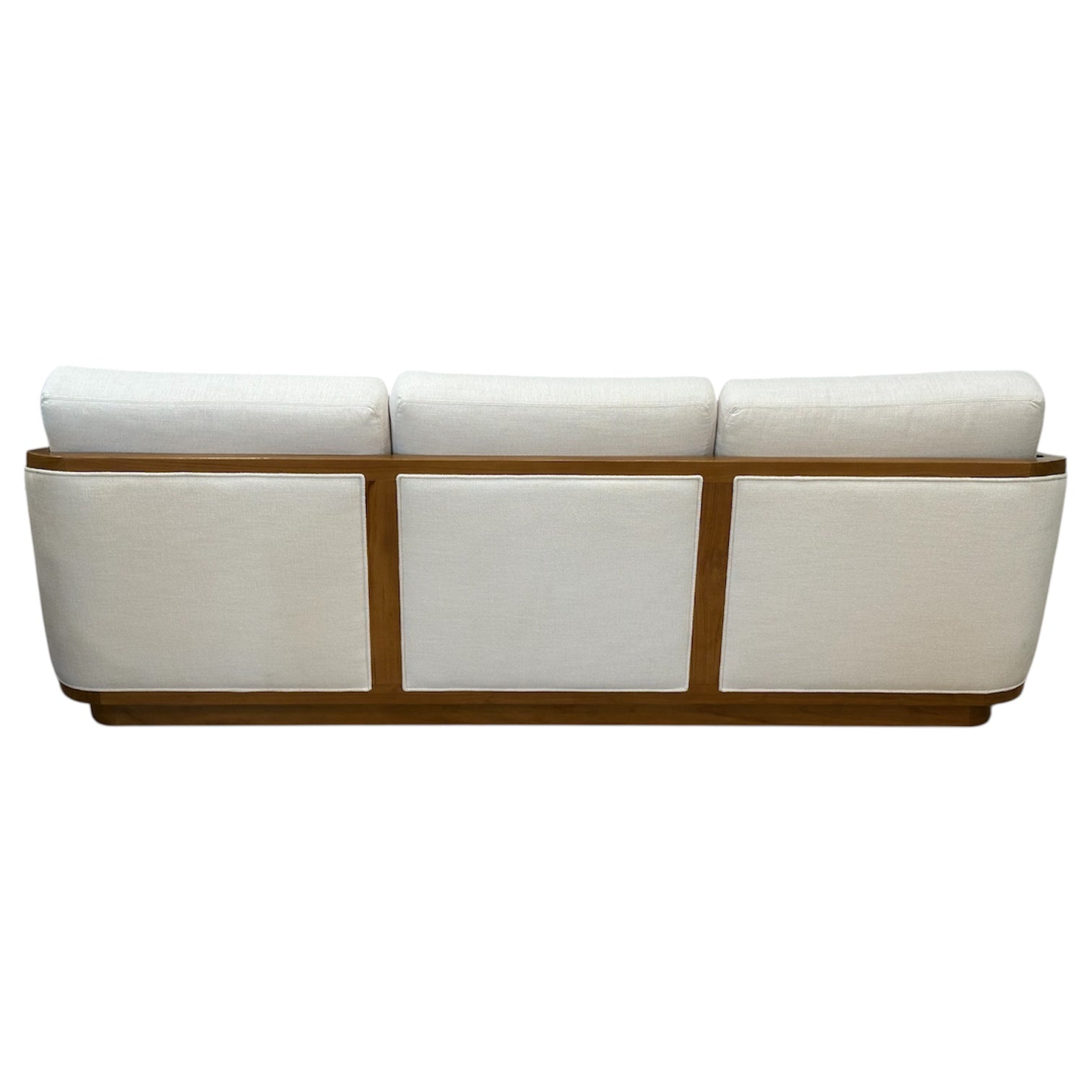 A rear view of the McGuire Furniture Schooner Sofa in Outdoor Ivory Chenille, featuring three cushions and a wooden frame, highlights naturalistic materials that lend coastal living charm.