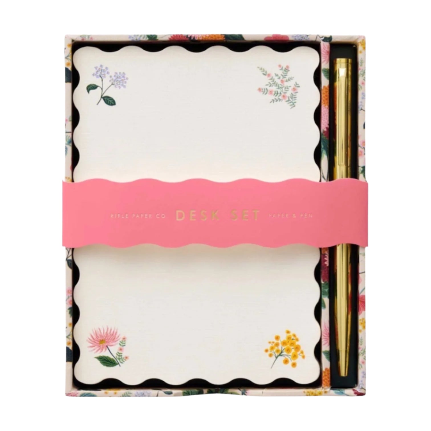 The Dahlia Collection Desk Set by Rifle Paper Co. includes floral stationery and a gold pen, boxed and wrapped in a pink band labeled "DESK SET.