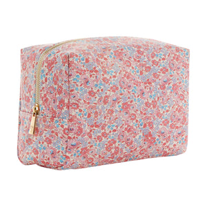 The TRVL Design Luxe Everyday Cosmetic Bag is a large rectangular pouch with a pink, red, and blue floral fabric pattern, featuring a zipper—perfect for cosmetics and shown on a white background.