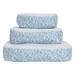 The Luxe Packing Cube Set of 3 by TRVL Design features rectangular bags with blue floral patterns, stacked on a white background—ideal for keeping your lightweight luggage neat and organized.