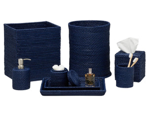 The Dalton Bath Collection by Pigeon & Poodle features navy blue rattan bathroom accessories, handmade with detailed craftsmanship—includes a wastebasket, tissue box cover, soap dispenser, toothbrush holder, tray, storage containers, and large basket.
