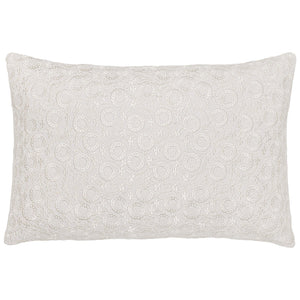 The Chandra Natural Kidney Pillow by John Robshaw features a white linen-cotton cover with an elegant circular floral embroidery, adding a romantic touch to your space.