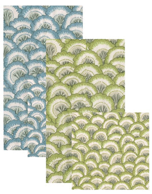 The Pontchartrain Scallop Collection by Caspari features four eco-friendly, triple-ply napkins—two blue and white, two green and white—with overlapping rectangular scalloped fan designs for stylish, sustainable table settings.