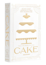 A white and gold box from PrintWorks featuring a three-tiered cake illustration and "The Essentials Cake Tools"—perfect as a Cake Kit or stylish kitchen decor.
