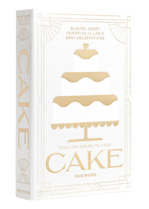 A white and gold box from PrintWorks featuring a three-tiered cake illustration and "The Essentials Cake Tools"—perfect as a Cake Kit or stylish kitchen decor.