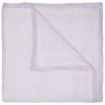 A folded John Robshaw Nandi Coverlet in lavender, with light purple and white stripes, features a turned-down corner and is crafted from soft cotton voile.