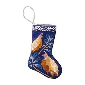 The Mignonne Gavigan: Quail Needle Point Stocking by Bauble Stockings features hand-stitched yellow birds and leafy branches on blue, with a white hanging loop—ideal for beginning a cherished family tradition.