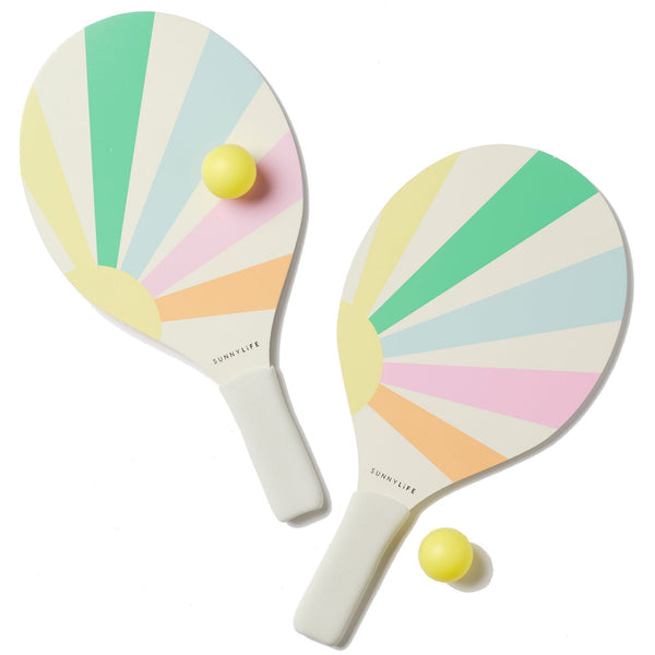 Two Sunnylife Beach Paddle Sets, Pool Side Pastel Gelato bats with a pastel fan design, each paired with a small yellow ball, isolated on a white background.