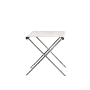 The Summit Furniture Sundeck Folding Director's Footrest features a white fabric seat and marine-grade stainless steel legs, shown against a plain white background, evoking classic campaign furniture style.