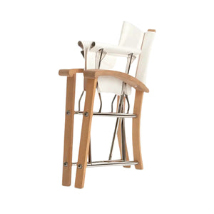 Two Sundeck Director's Chairs by Summit Furniture, featuring plantation-grown teak legs, marine-grade stainless-steel footrests, and white seats, are stacked together against a white background.