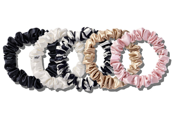 A collection of Slip Silk Midi Scrunchie Sets in black, white, and pink colors arranged in a circle on a white background.