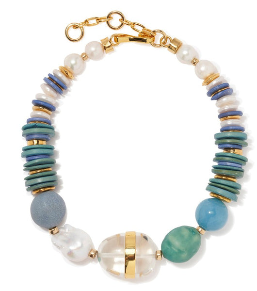 A Lizzie Fortunato Neptune Collar featuring freshwater baroque pearls, blue and green beads, and a golden clasp.