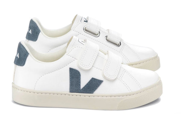A pair of Veja Kids' Esplar Velcro Sneakers with velcro straps and a dark blue accent on the sides, made from Amazonian rubber and recycled polyester.