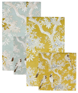 Four rectangular fabric swatches from Caspari's Scenic Songbirds Collection—two light blue, two yellow, each a different size—overlap in an alternating pattern; perfect as stylish, biodegradable napkins.