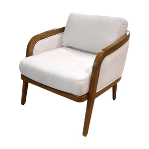 The Schooner Lounge Chair in Outdoor Ivory Chenille by McGuire Furniture features a modern design with curved armrests, a wooden frame, and four angled legs, evoking coastal living with its natural materials and light ivory upholstery.