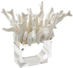 The Amalfi Napkin Ring Set by Kim Seybert features clear rectangular rings topped with abstract white ceramic clusters, reminiscent of natural coral—ideal for adding a stylish touch to any poolside party.