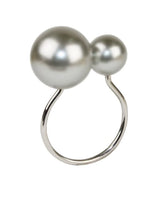 The Kim Seybert Pearl Napkin Ring features two large, round gray pearls of different sizes set on a simple curved band—an elegant accessory for wedding tables or a unique bridal shower gift.