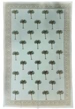 The Les Ottomans Green Palm Trees Tablecloth features an evenly spaced palm tree pattern with decorative borders, highlighting the charm of block printing in a subtle yet colourful design.