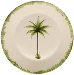 The Palm Tree Dinnerware Collection by Les Ottomans features a cream ceramic plate with a green rim and hand-painted tropical tree, crafted in Italy.