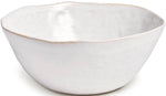 The Burlington Cloud Serving Bowl by Simon Pearce is a white, handmade ceramic piece with a freehand pinch-pot design, an uneven rim, and a smooth matte finish.