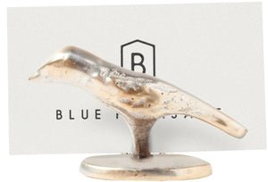 A set of four Zachary Tarnished Silver Place Card Holders, by Blue Pheasant, showcases abstract bird-shaped sculptures elegantly perched on small circular bases.