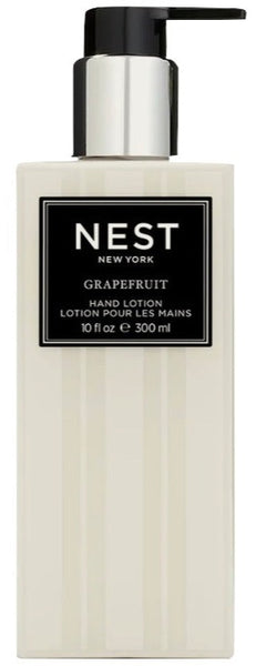 A bottle of NEST Grapefruit Hand Lotion with a white label infused with botanicals and antioxidants.