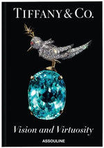 Cover of the elegant book "Tiffany: Vision & Virtuosity" by Assouline, featuring a jeweled bird on a stunning blue gemstone set against a black background, symbolizing elegance and the allure of gemstones.
