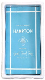 The Hampton Faux Bamboo Fretwork Guest Towel Tray by Two's Company is a white rectangular holder with faux bamboo detailing, perfect for displaying a stack of paper guest towels in elegant Chinoiserie-inspired style.