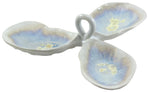 The AE Ceramics Condiment Triple Tray Collection features a three-section ceramic dish with a central handle, blue and white gradient glaze, and beige accents—ideal for serving oysters or mignonette sauce.