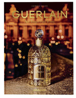 Cover of the book "Guerlain An Imperial Icon" by Assouline featuring a gold ornate Bee Bottle of perfume in front of a blurred nighttime background.