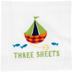 August Morgan’s Three Sheets Cocktail Napkins feature an embroidered sailboat, two blue fish, anchor, and “THREE SHEETS” in green—an elegant addition to any napkin set.