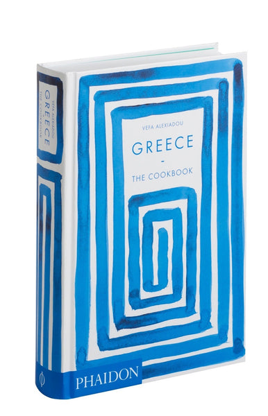 A hardcover copy of "Greece: The Cookbook" by Vefa Alexiadou, featuring a blue and white abstract cover design, isolated on a white background, explores the intricacies of Greek
Phaidon's Greece: The Cookbook