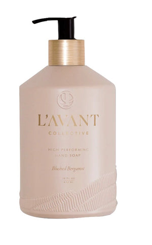 A luxurious 16 fl oz beige bottle of L’Avant Collective Blushed Bergamot Hand Soap with a black pump and gold accents, offering an elegant citrus aroma.