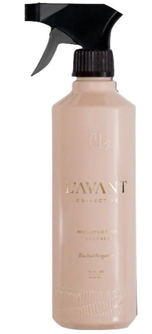 A beige spray bottle labeled "L'Avant Collective Multipurpose Cleaner Blushed Bergamot 16oz" with a black trigger nozzle, featuring plant-based ingredients.