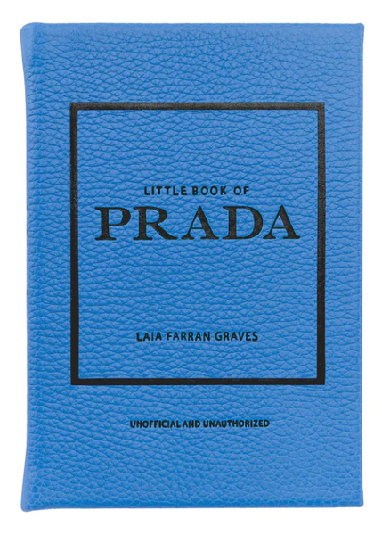 A blue book titled "Little Book of Prada" by Graphic Image, labeled as unofficial and unauthorized, details the history of the luxury fashion house.