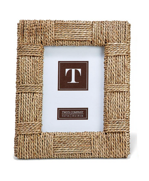 The Sea Grass Frame Collection by Two's Company features a rectangular braided frame in earthy tones, displaying a "T" placeholder and sizing info: 5x7 in | 13x18 cm.