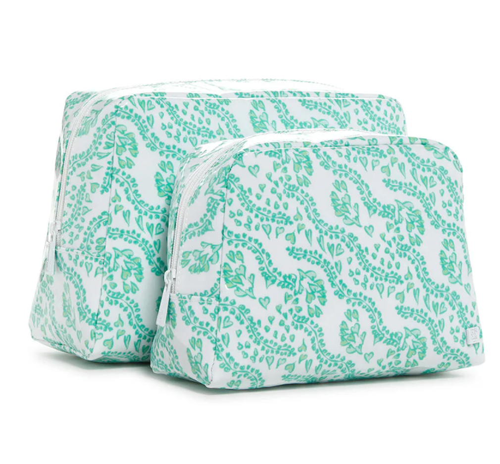 The TRVL Design Luxe Gloss All Heart Travel Set in Kelly Green features two zippered fabric pouches—one large, one small—with matching green botanical patterns, perfect for cosmetics or travel accessories, shown side by side on a white background.
