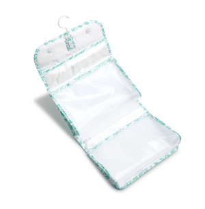 The TRVL Design Luxe Gloss All Heart Travel Set in Kelly Green is a hanging toiletry bag with multiple zippered compartments, floral trim, and a metal hook—ideal for organizing essentials on your travels.