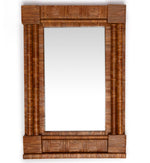 The Column Mirror by Sharland England features a wooden frame with vertical and horizontal ridged patterns, adding handmade charm and style to any space.