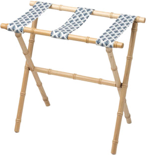 The Sorella Glenn Maple Luggage Rack, Highlands Indigo, features sturdy maple hardwood with bamboo-style legs and three fabric straps in a blue leaf pattern—perfect for convenient suitcase storage.