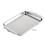 A rectangular Hestan Provisions OvenBond Sheet Pan from the Sheet Pan Collection, crafted from triple-bonded clad stainless steel with raised edges and side handles, is shown next to a quarter for scale. This sheet pan is oven safe up to 600°F.
