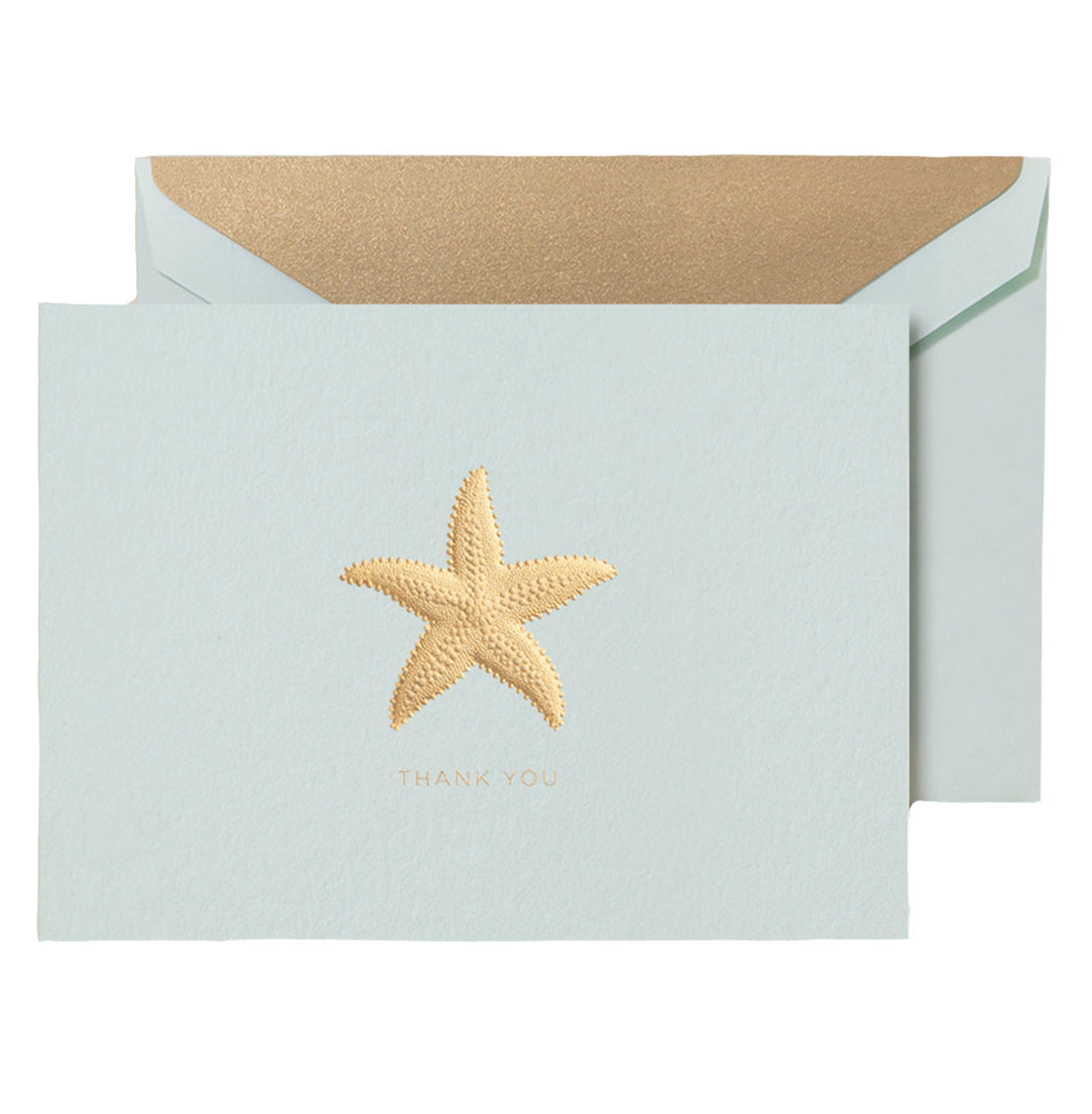 The Crane Thank You Gold Starfish Folded Card Set features a light blue Beach Glass card with a metallic gold starfish design and comes with a matching gold-lined envelope.