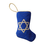 The Bauble Stockings Star of David Needle Point Stocking features a blue design with a gold Star of David and a shimmering gold loop, perfect for holiday gifting and displayed on a white background.