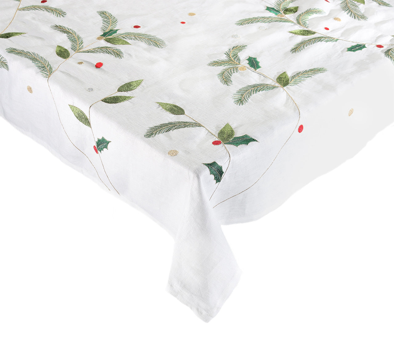 The Kim Seybert Christmas Carol Table Linen Collection features a white linen tablecloth embroidered with green pine branches, holly leaves, red berries, and gold dots—perfect for a festive holiday table setting.