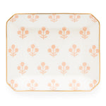 The Rose Floral Trinket Tray by Sugar Paper is a rectangular white ceramic tray with rounded corners, featuring a repeating light pink floral pattern and elegant gold detailing along the edge.