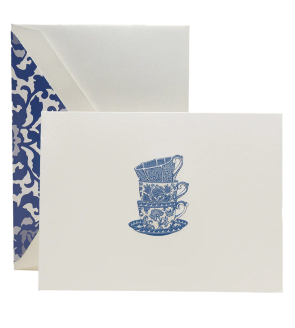 The Crane Tea Cups Card Set includes pearl white folded notes with an illustration of three stacked blue teacups and saucers, each paired with a blue and white toile-lined envelope—ideal for thoughtful thank-you notes.