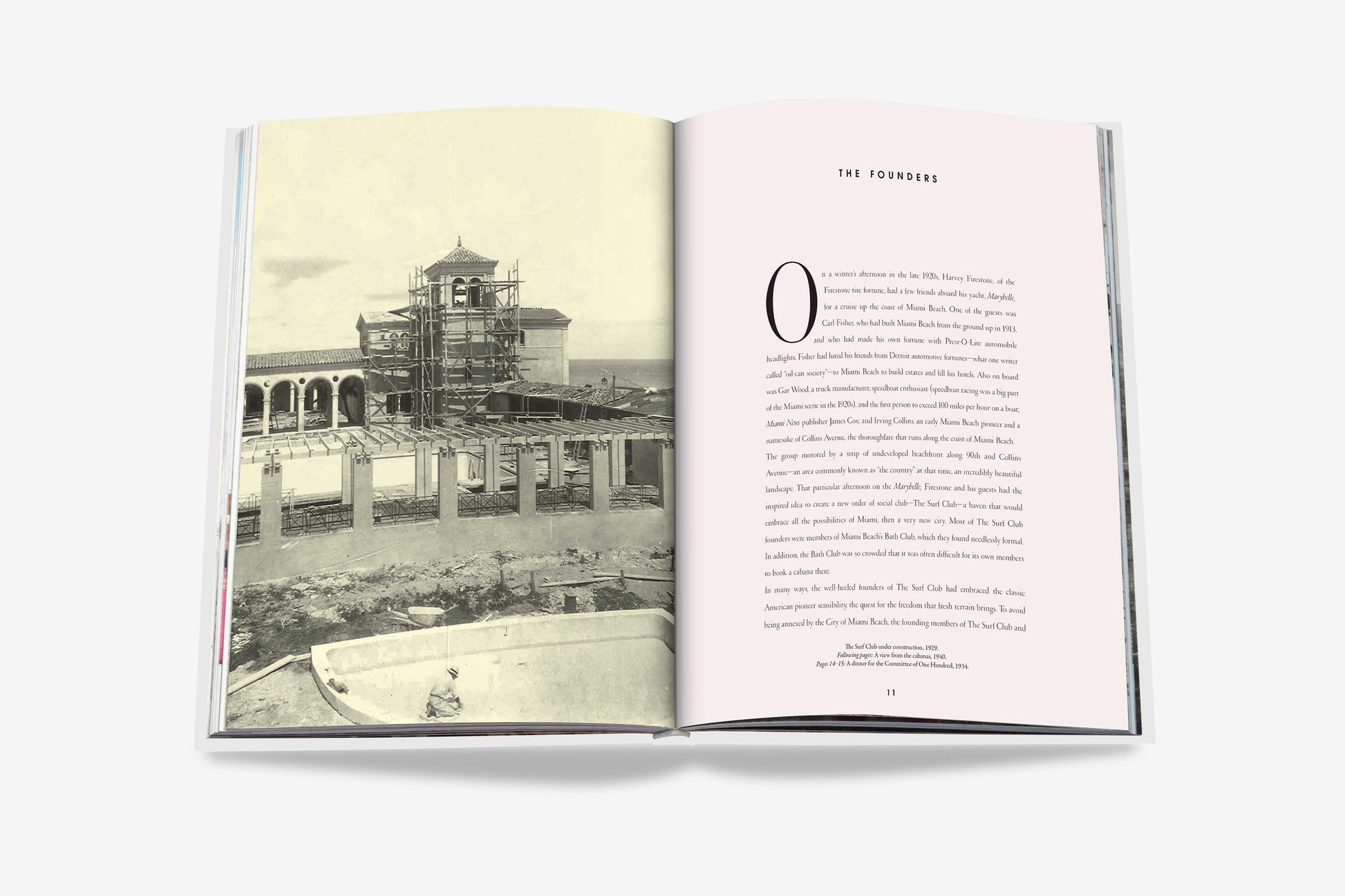 An open book by Assouline entitled "The Surf Club" displays a black-and-white photo of a building under construction on the left page and text titled "The Founders" on the right page, offering a glimpse into the luxurious history of The Surf Club in Miami.